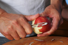 A man peeling an apple hears the sounds
