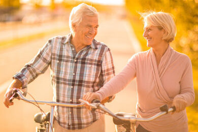 Couple walking down road with bikes